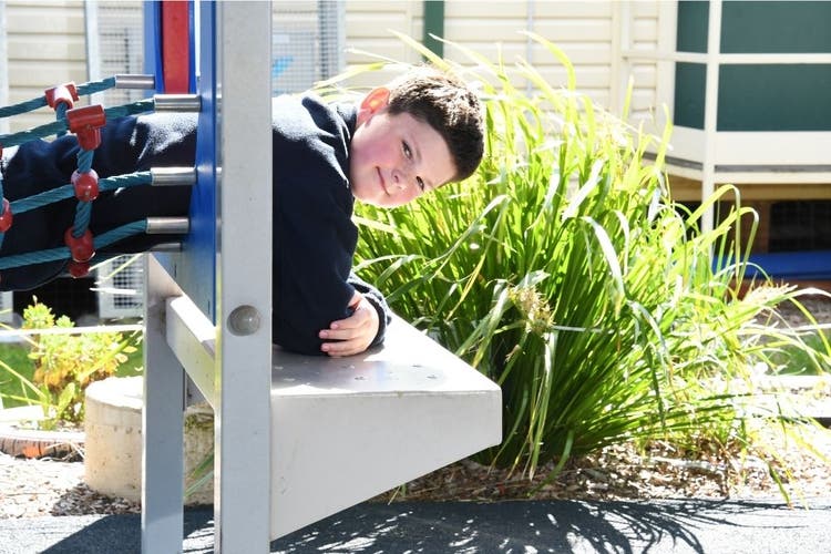 A student on the play equipment in the playground