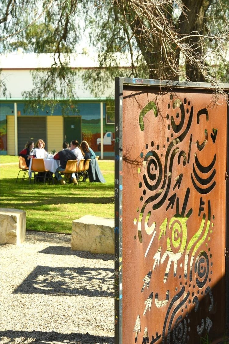 Group of students enjoying lunch on the lawn